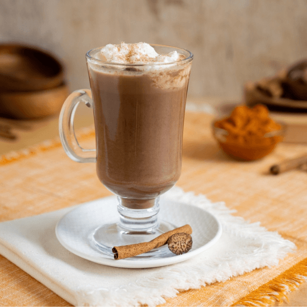 Glass filled with hot chocolate topped with whipped cream